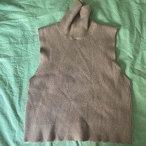 Light pink, cropped, knit, ribbed, sleeveless sweater vest with thick turtleneck